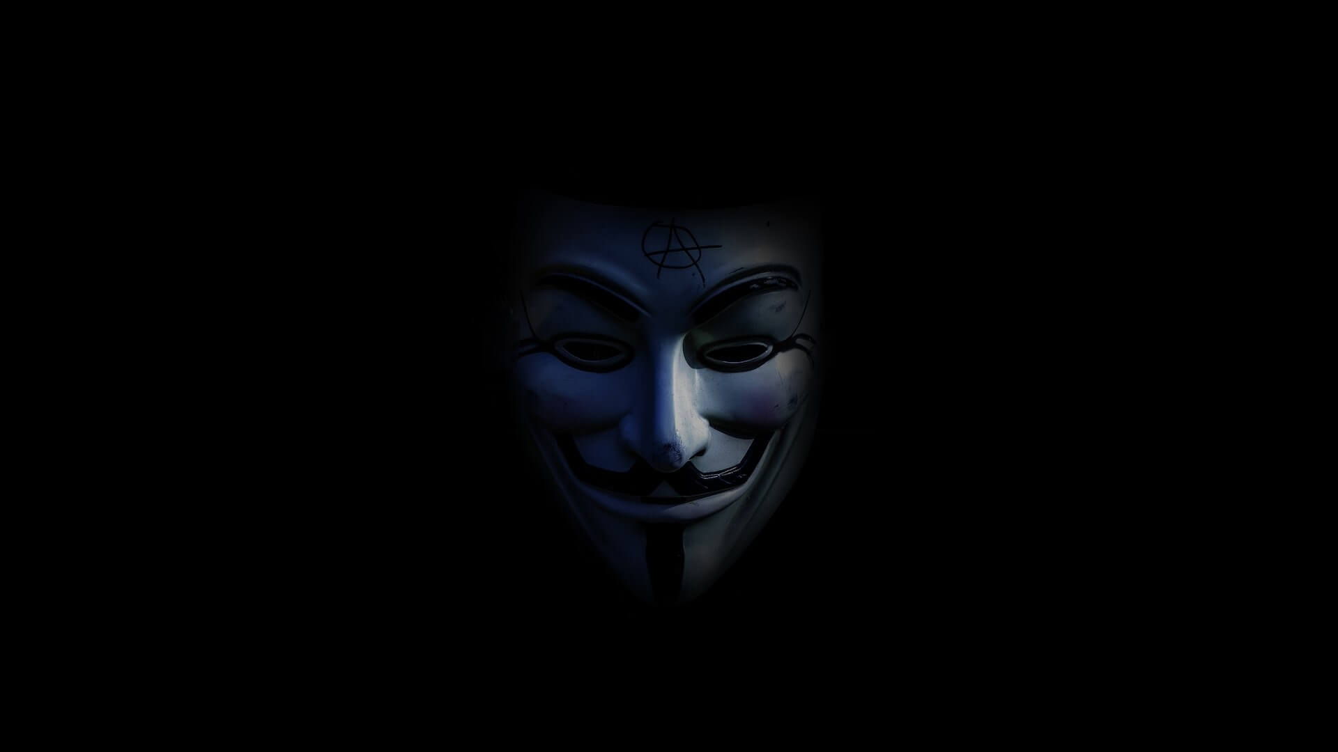 A theatrical mask resembling a face with a mustache, set against a dark and mysterious backdrop.